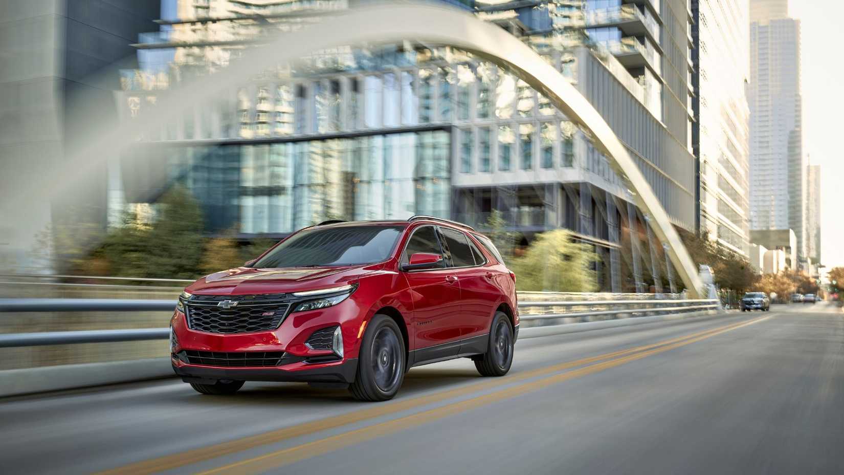 Dynamic front 3/4 shot of a red 2024 Chevrolet Equinox.