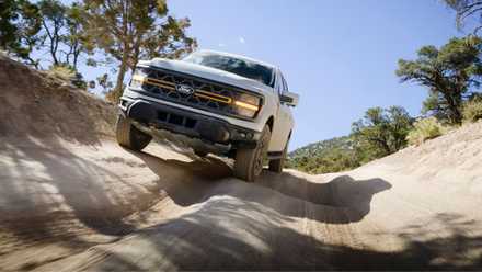 Dynamic front-end shot of a 2024 Ford F-150 Tremor off-roading.