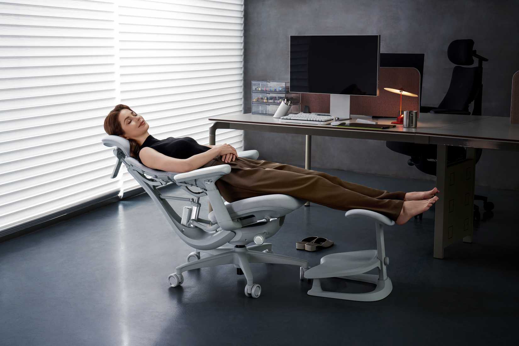 Person lounging in LiberNovo Omni chair.