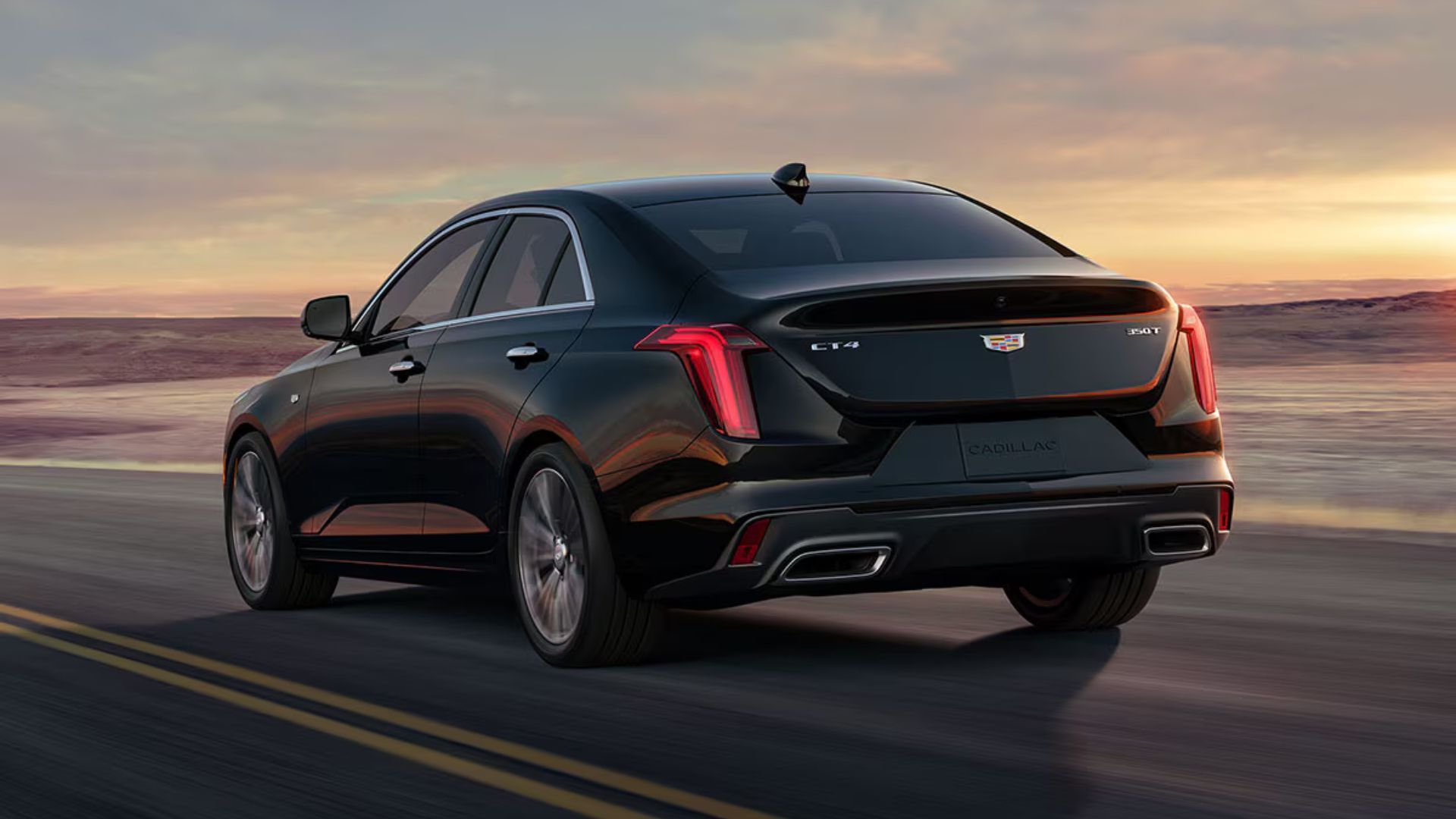Dynamic rear 3/4 shot of a black 2026 Cadillac CT4.