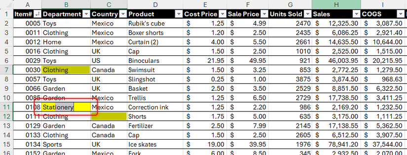 Uma célula em branco do Excel, destacada em amarelo, está sendo preenchida com a palavra “artigo de papelaria”.