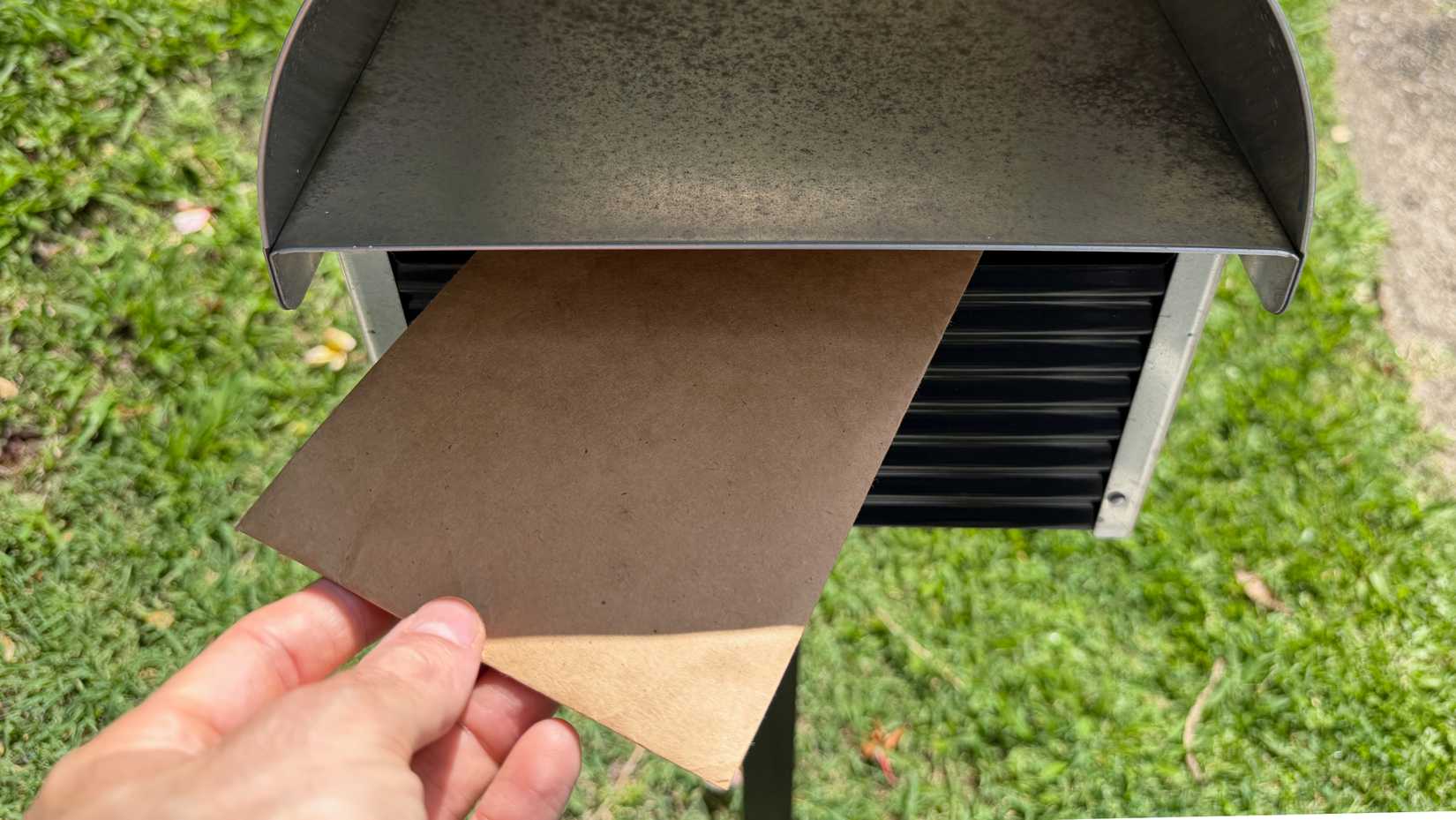 A letter being posted through a mailbox.