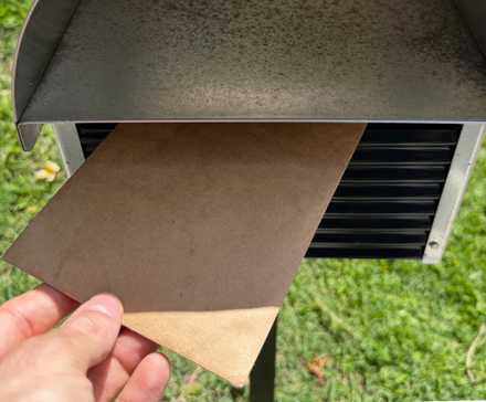 A letter being posted through a mailbox.