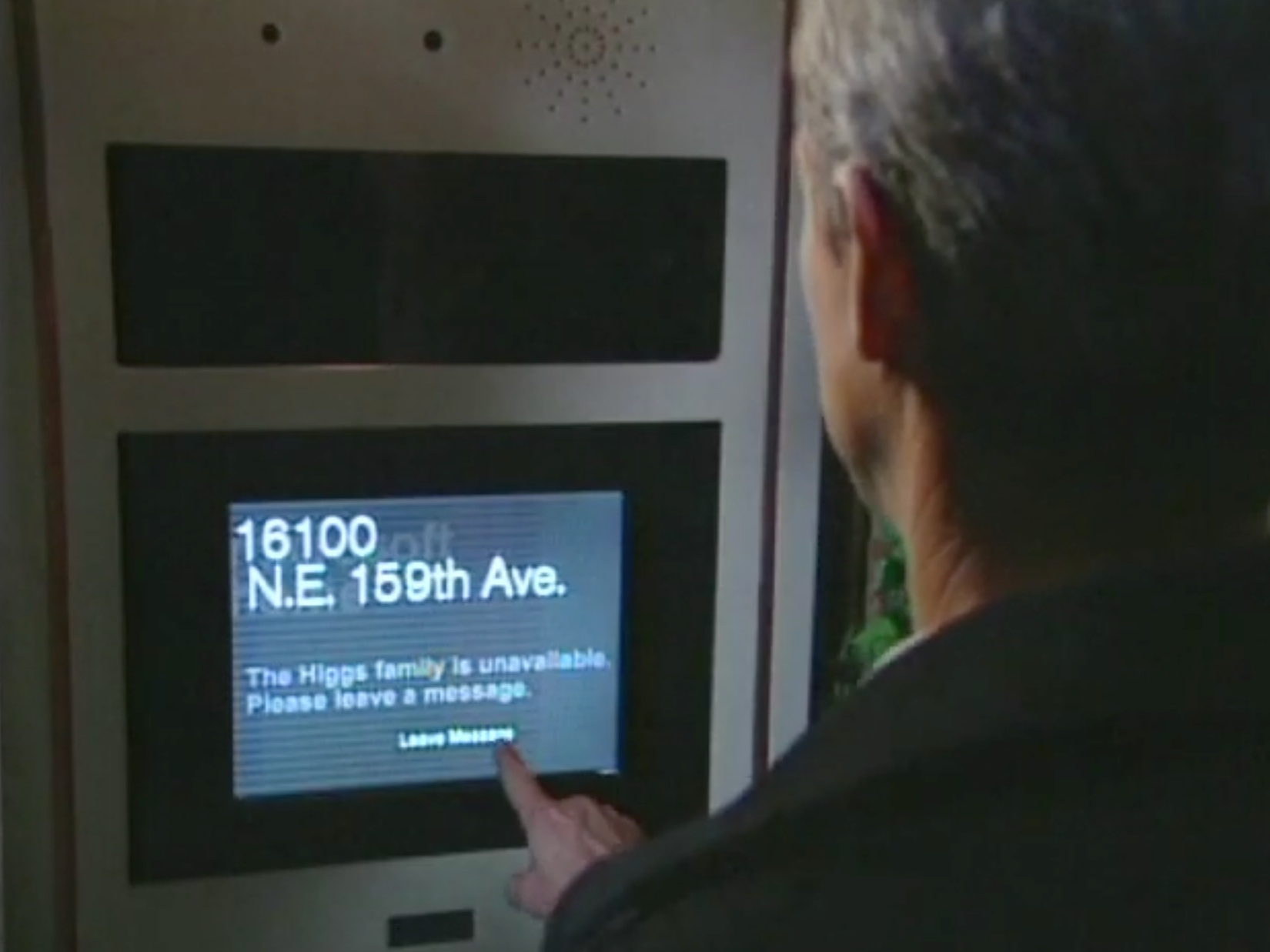 A salesman waits at a door but can only leave a message.