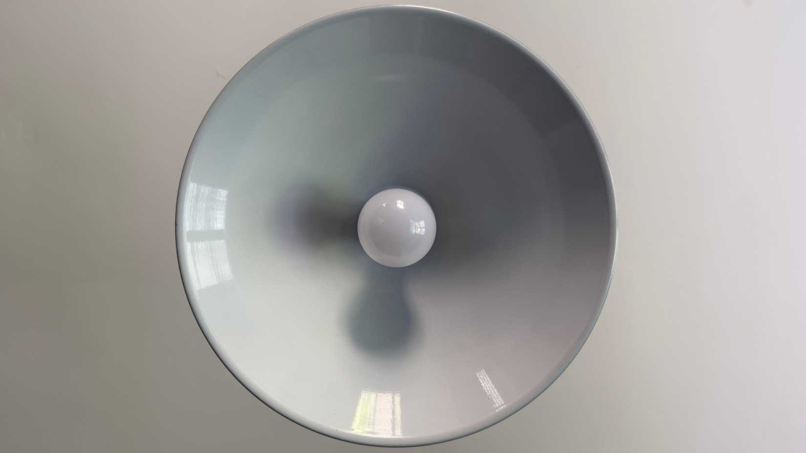 An IKEA smart bulb in a kitchen overhead light.