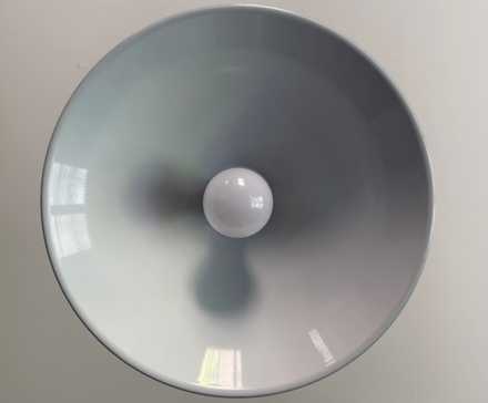 An IKEA smart bulb in a kitchen overhead light.