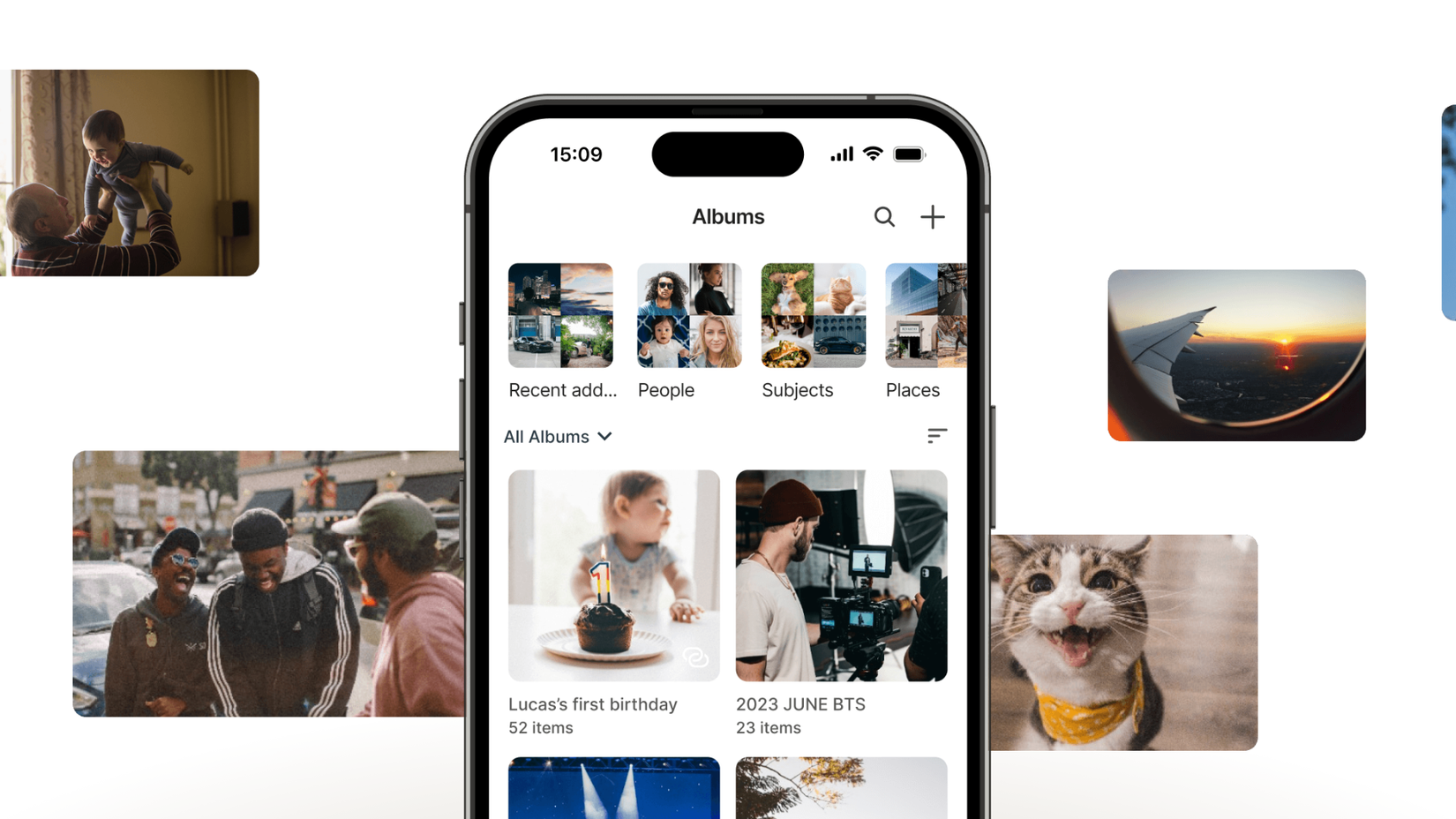 An iPhone showing the Synology BeeStation app with pictures behind it.