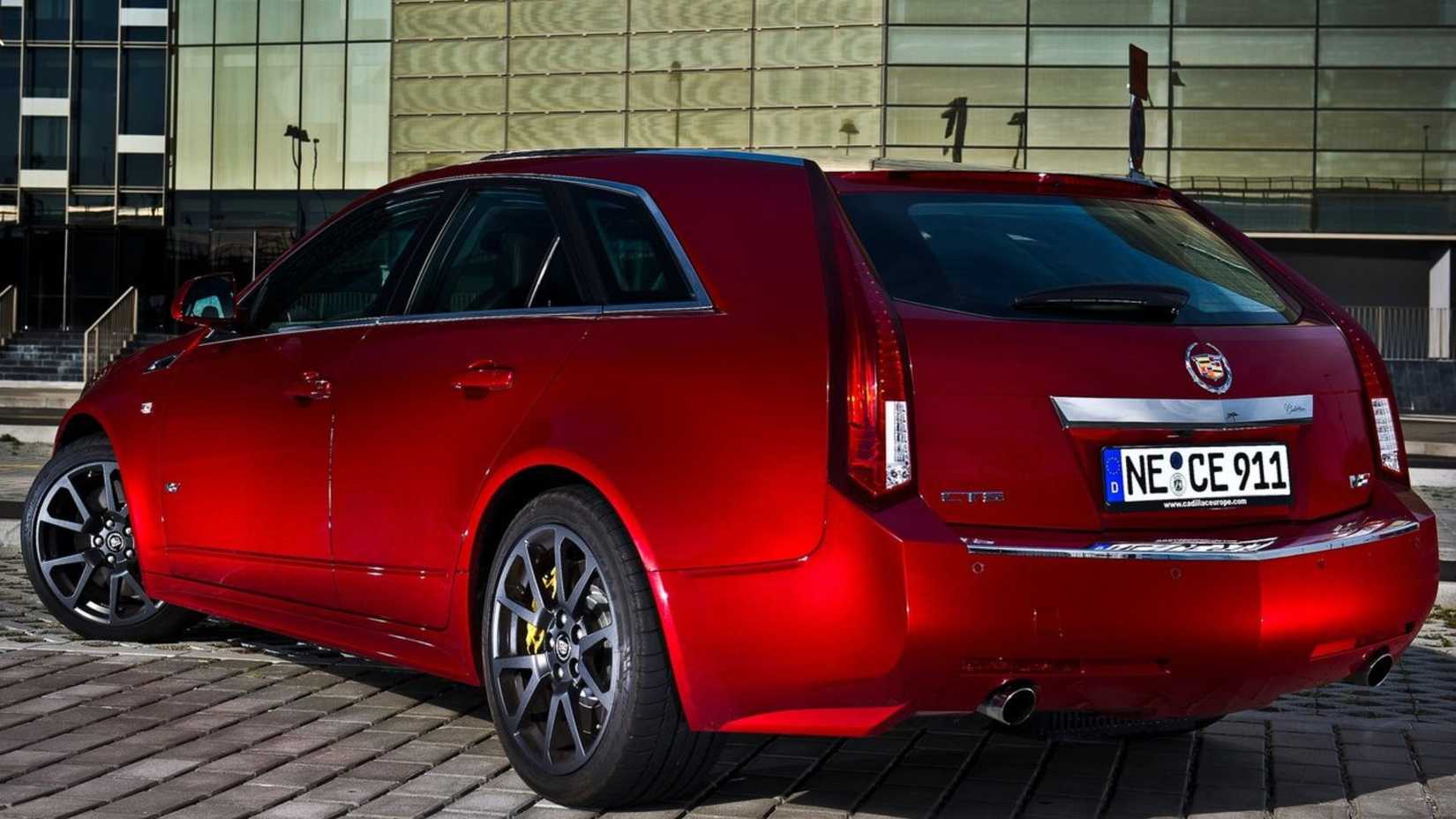 Static rear 3/4 shot of a red 2011 Cadillac CTS-V Wagon parked on cobbles.