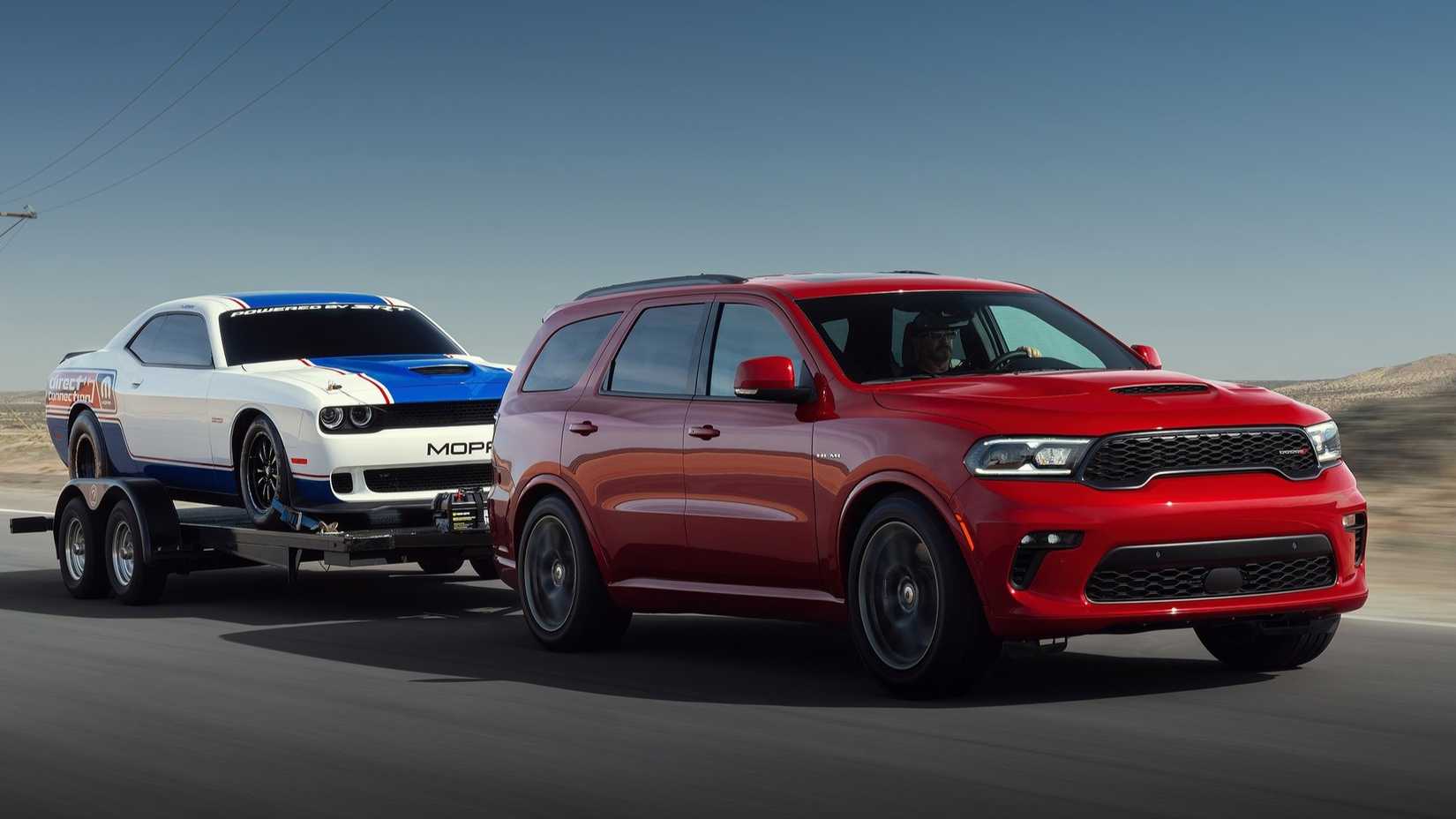 Front 3/4 shot of a 2021 Dodge Durango towing a Dodge Challenger 