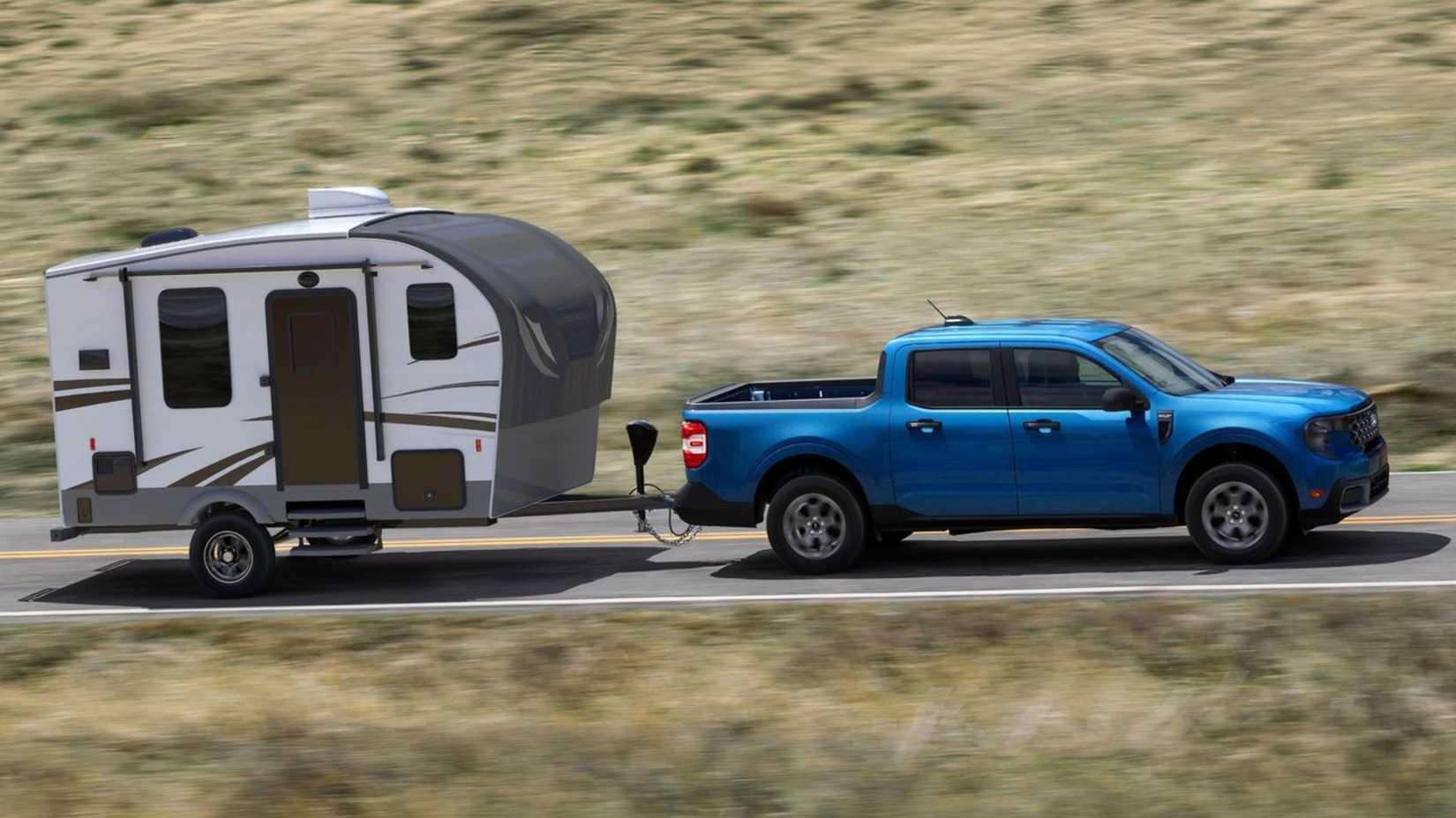 Dynamic side profile shot of a blue 2025 Ford Maverick towing a trailer.