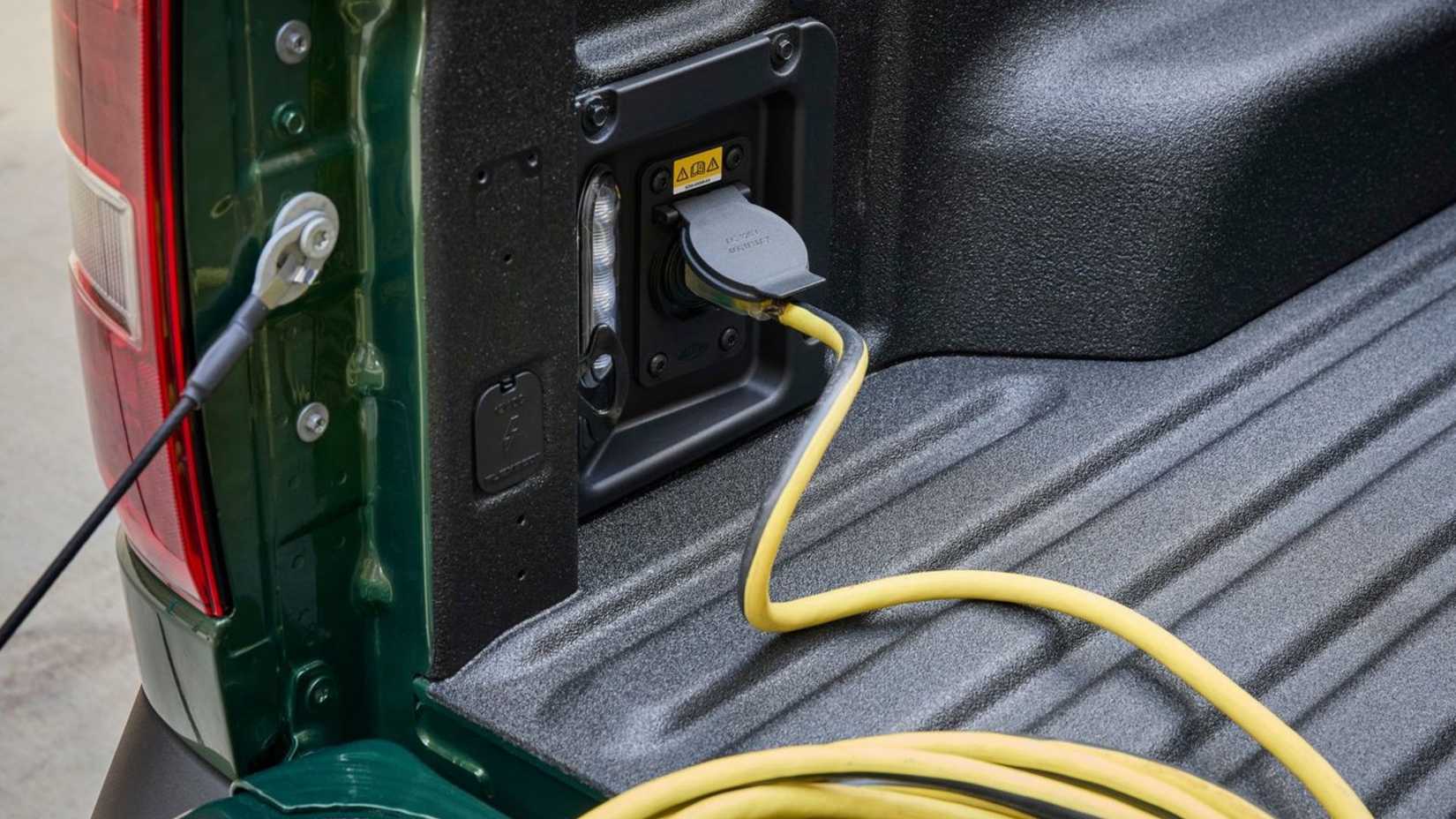 Close-up shot of an electrical cable plugged into the socket in the bed of a 2025 Ford Maverick.