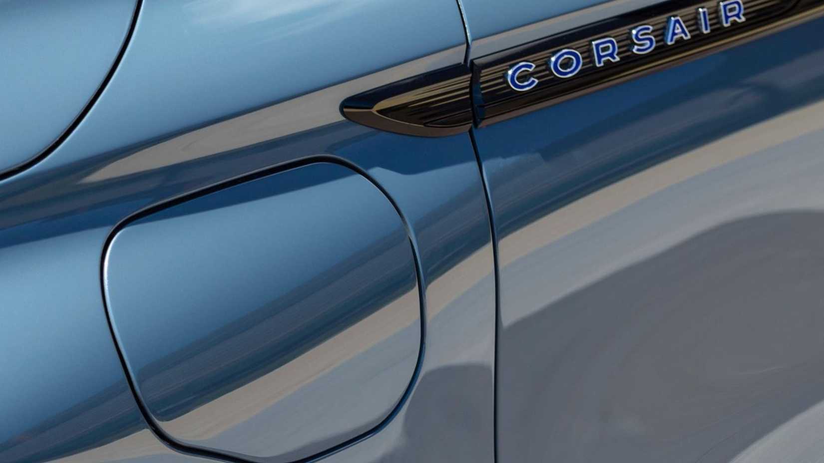 Close-up shot of the charging port door on the wing of a gray 2023 Lincoln Corsair.