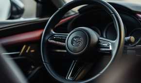 Close up of the steering wheel in a 2021 Mazda 3