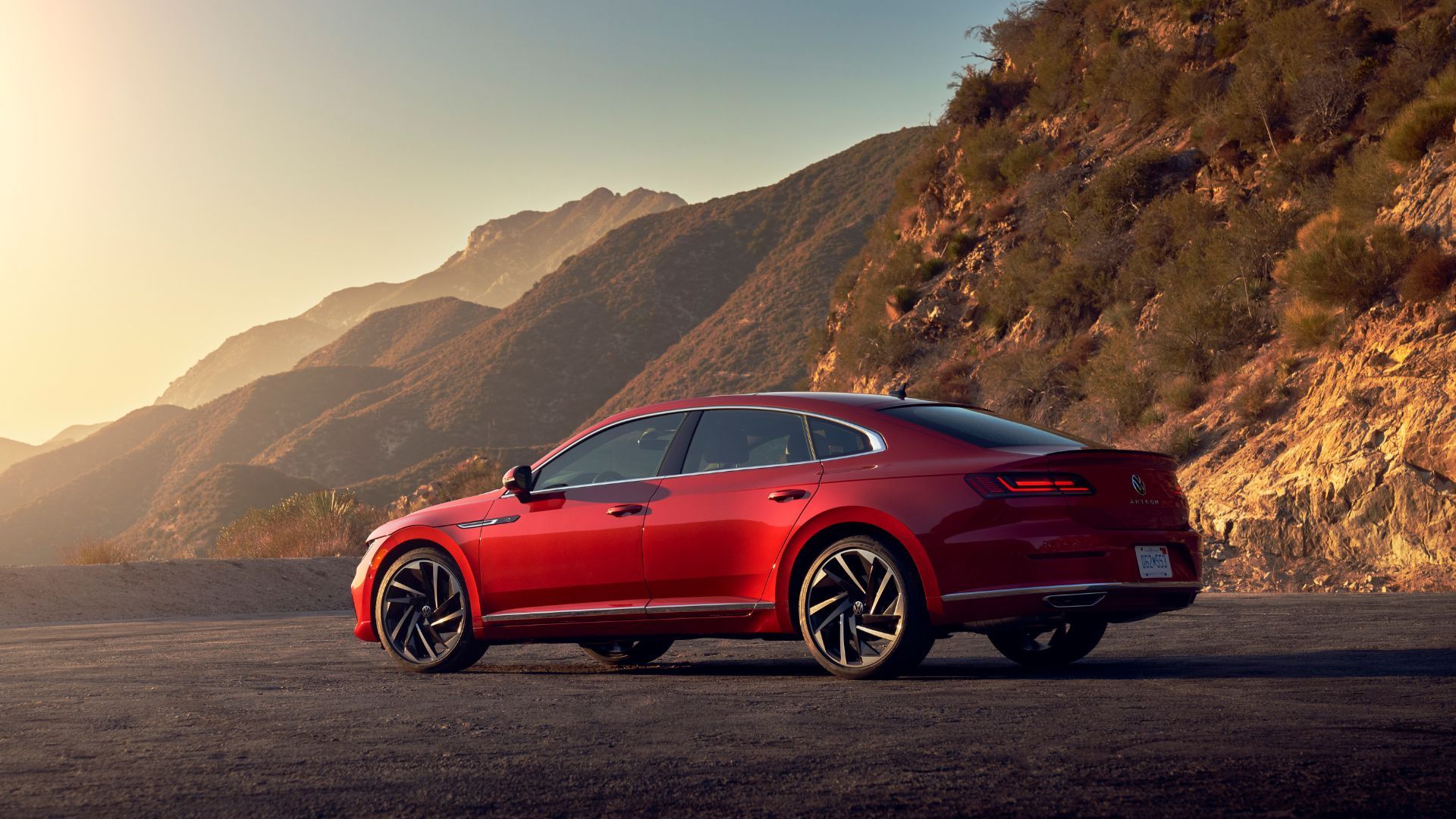 Static rear 3/4 shot of a red 2021 Volkswagen Arteon.