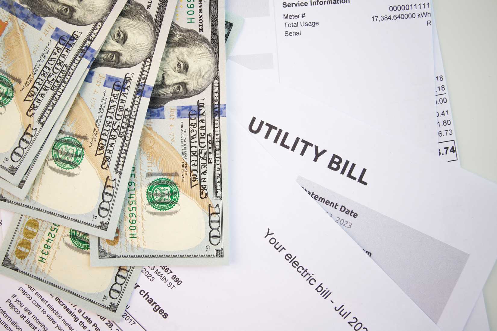 A utility bill next to money.