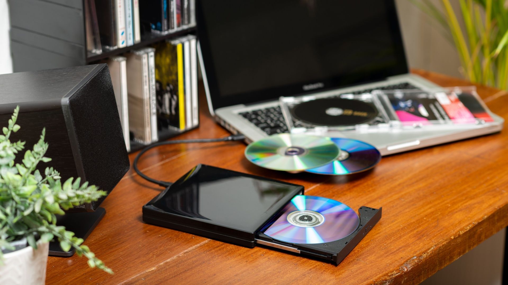 Portable external DVD, CD Drive connected to the laptop. Optical drive for player and burner disc for computer.
