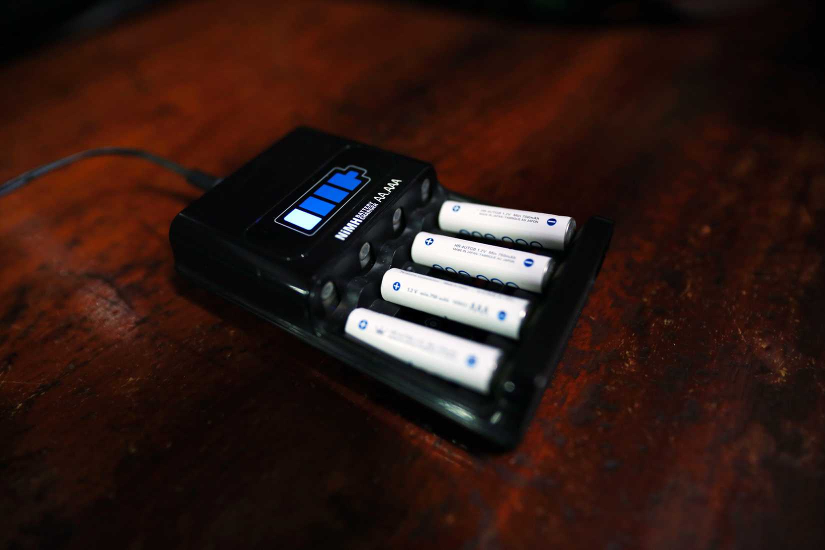 A charger filled with AA NiMH batteries.