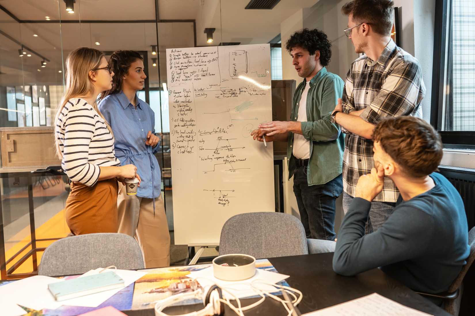 A group of stakeholders collaborating with a programmer on a project.