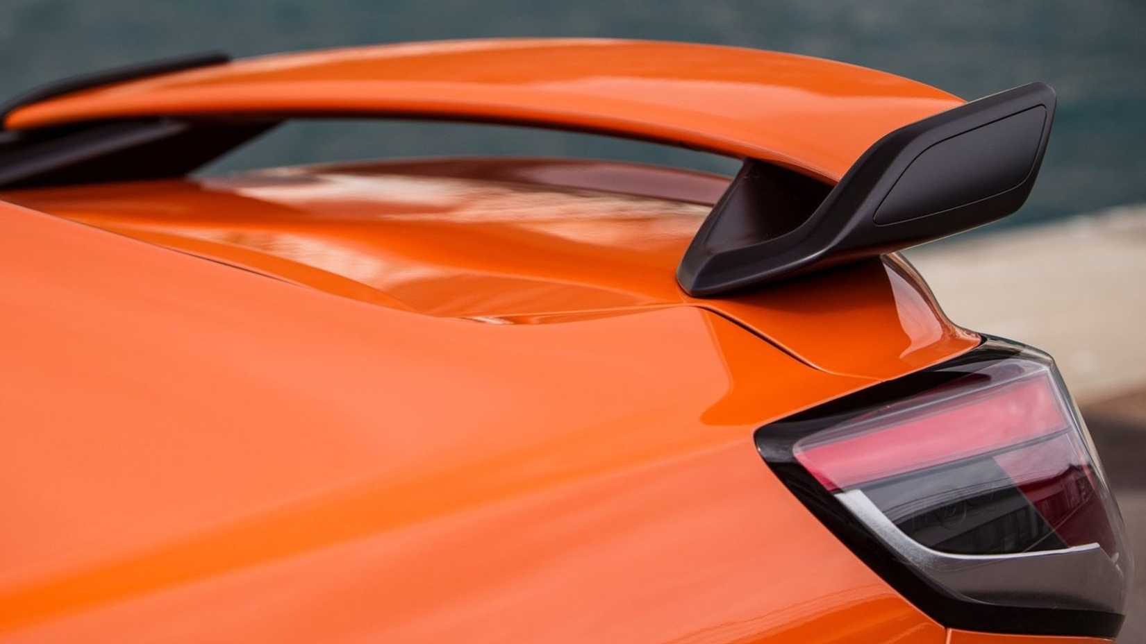 Close-up shot of the spoiler on an orange 2014 Vauxhall VXR8.