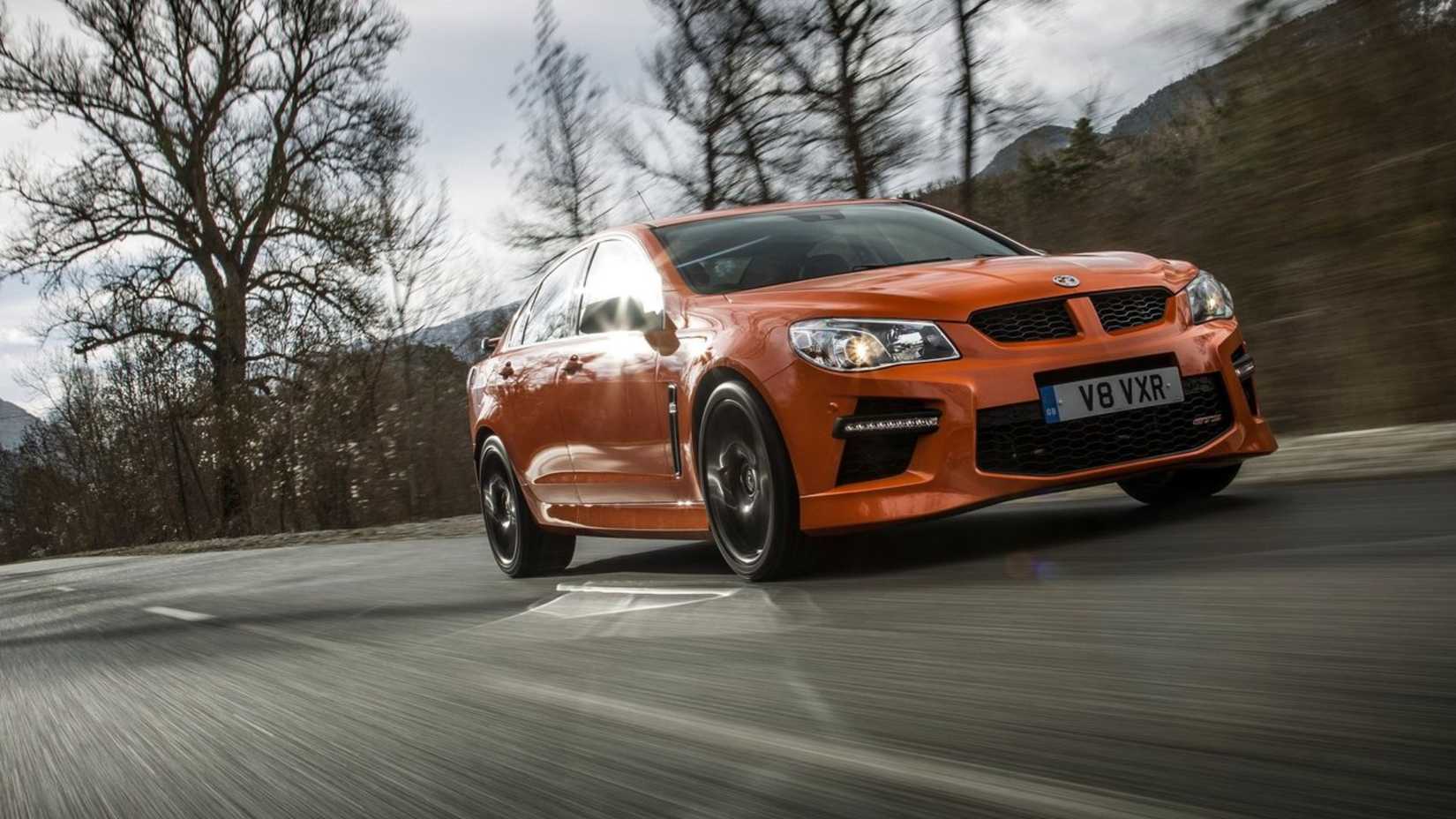 Dynamic front 3/4 shot of an orange 2014 Vauxhall VXR8.