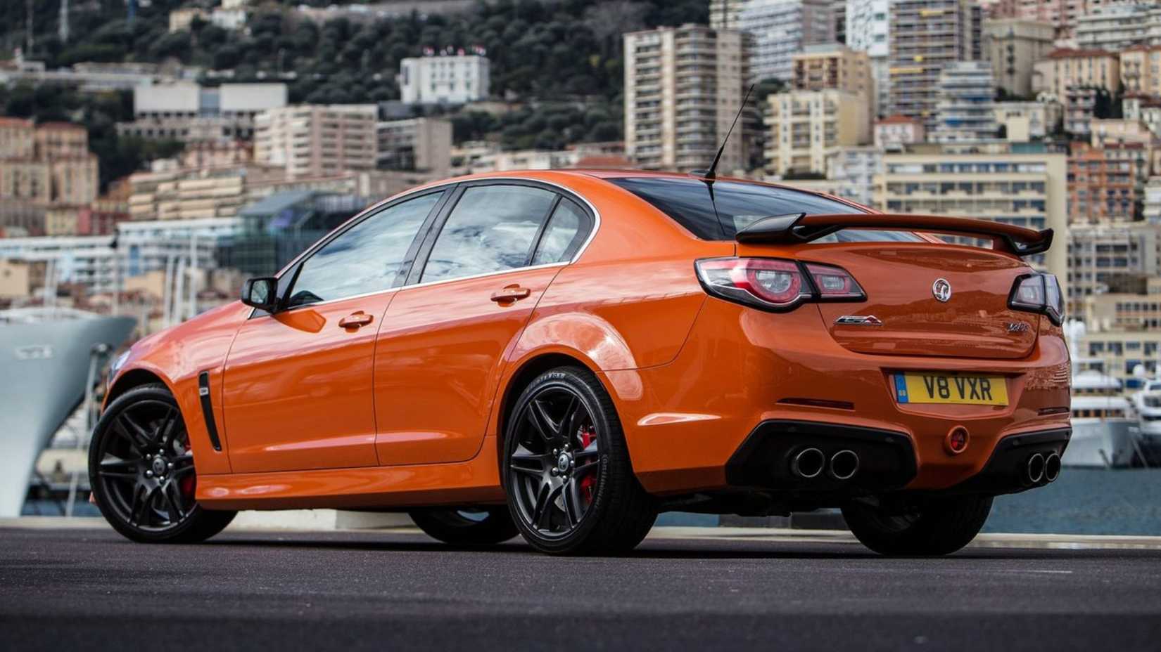 Static rear 3/4 shot of an orange 2014 Vauxhall VXR8.