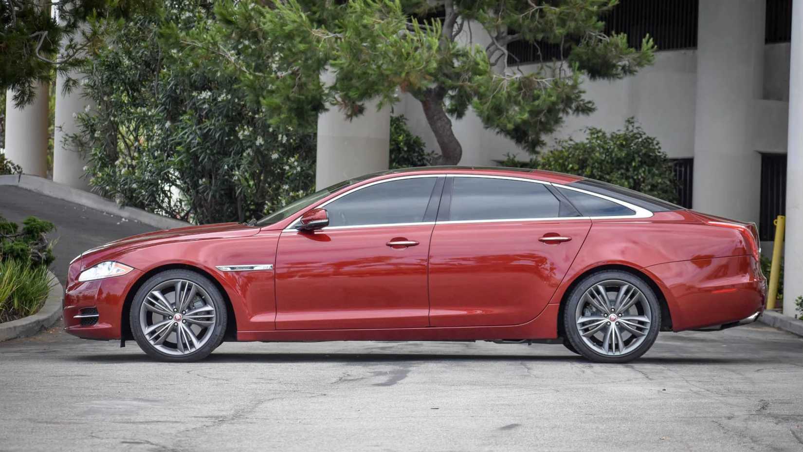 Static side shot of a red 2011 Jaguar XJL Supersport.