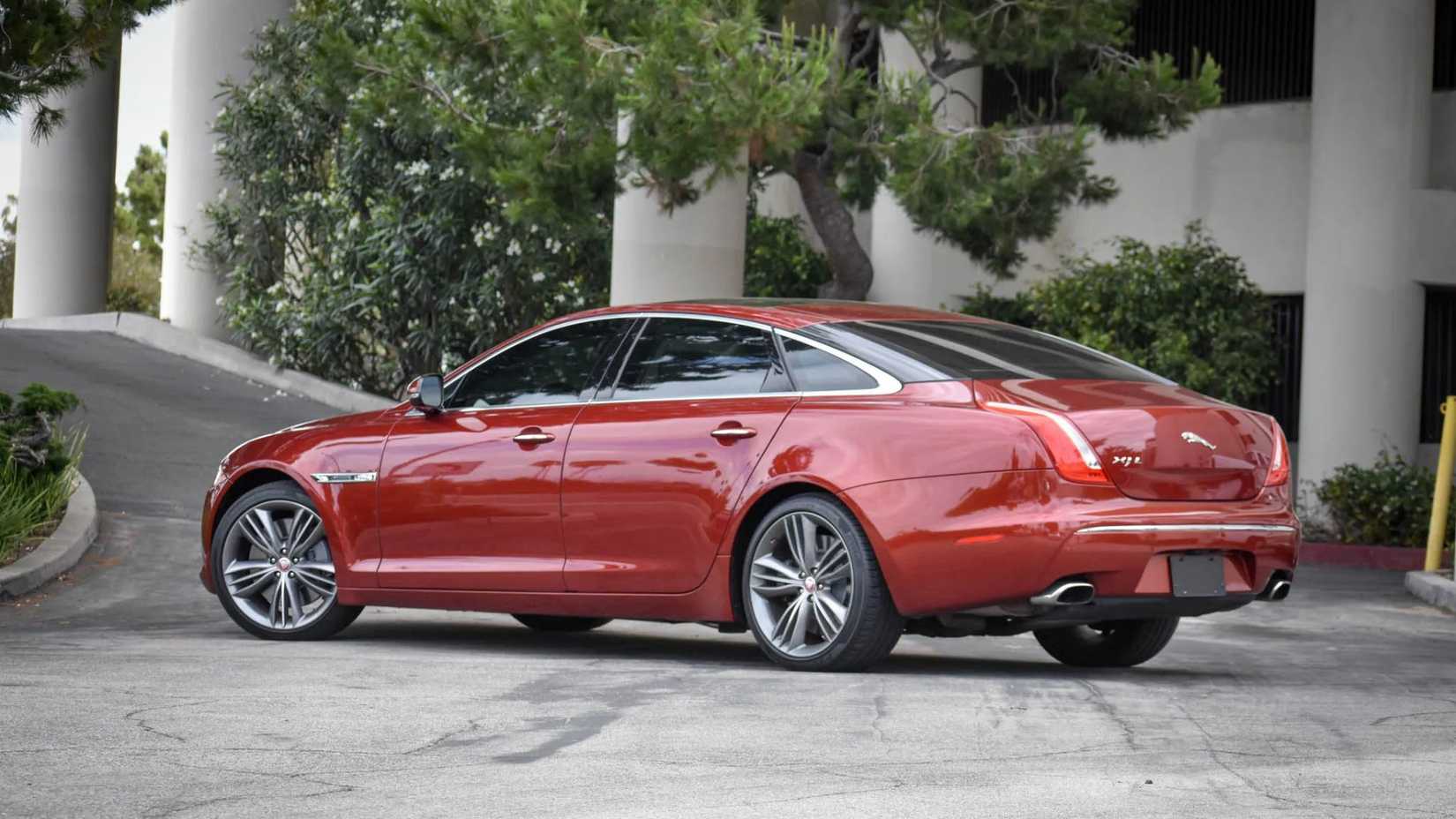 A still 3/4 scale shot of the rear of a red 2011 Jaguar XJL Supersport.