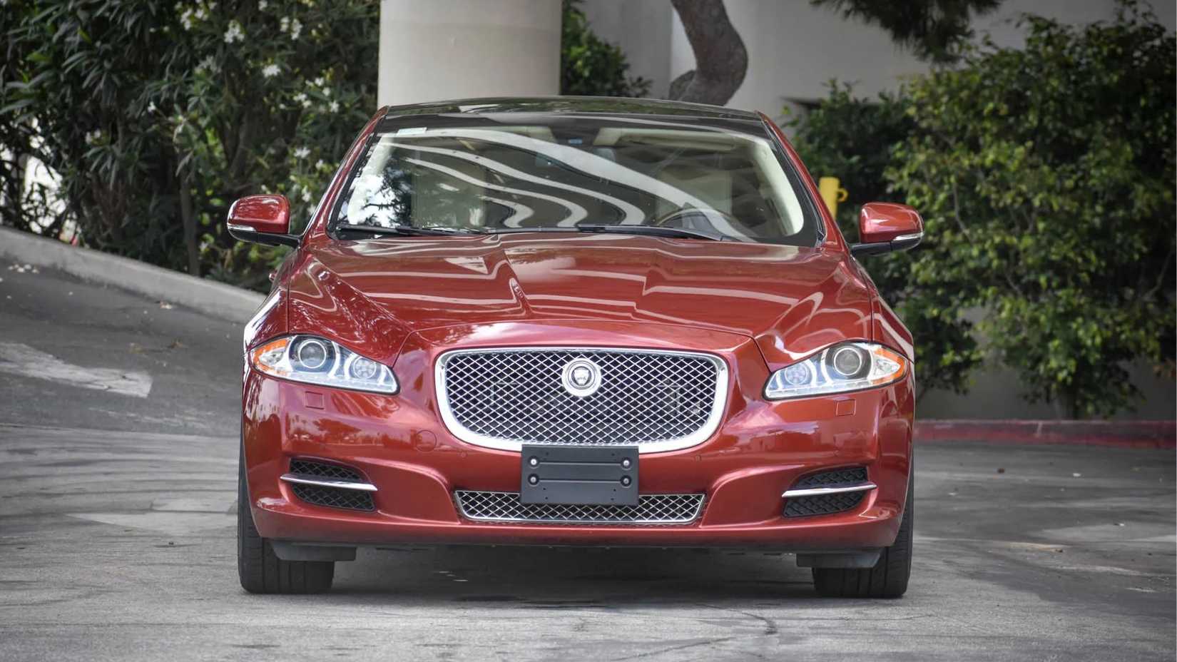 A still shot of the front end of a red 2011 Jaguar XJL Supersport.