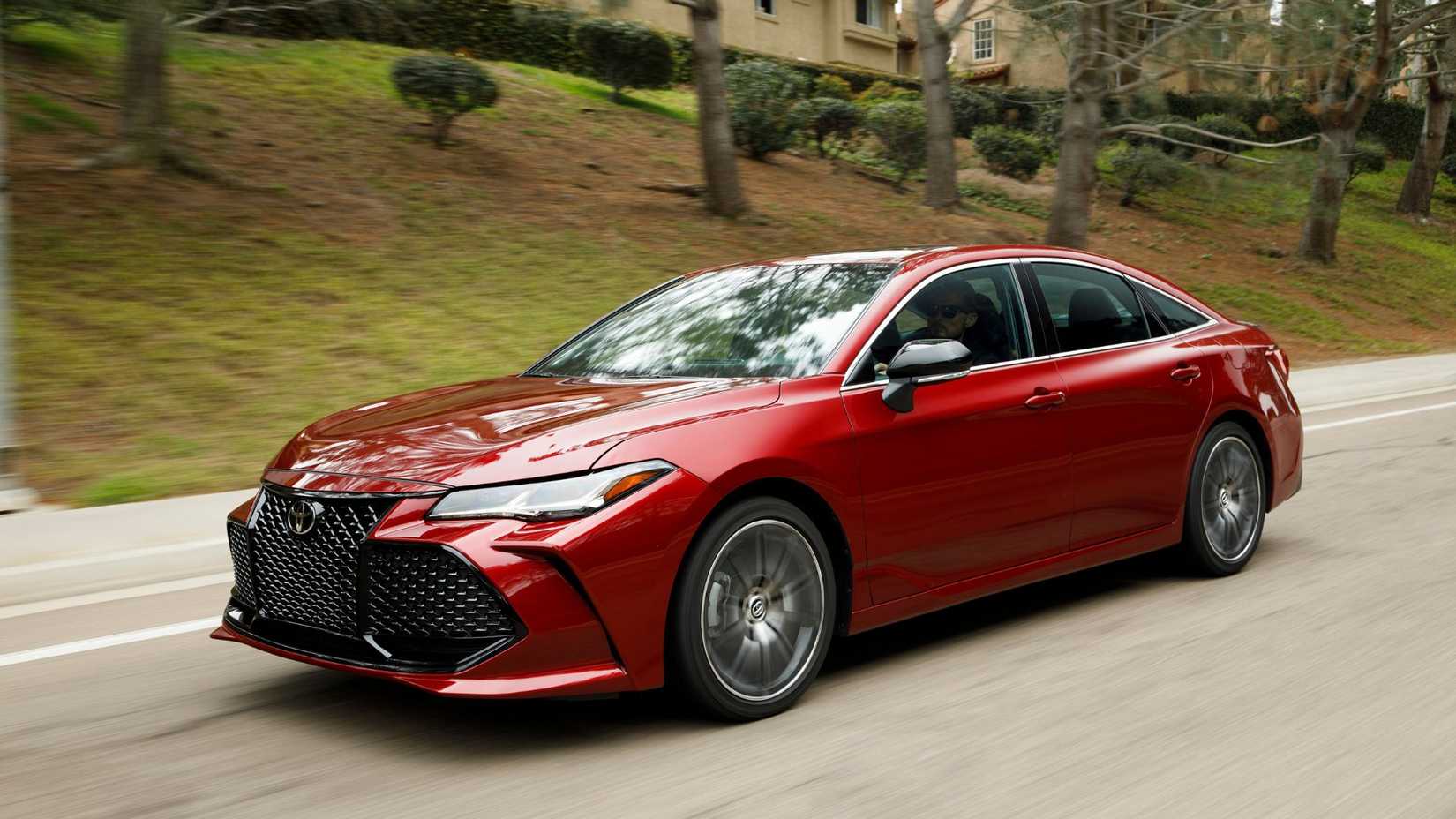 Dynamic front 3/4 shot of a red 2022 Toyota Avalon Touring.