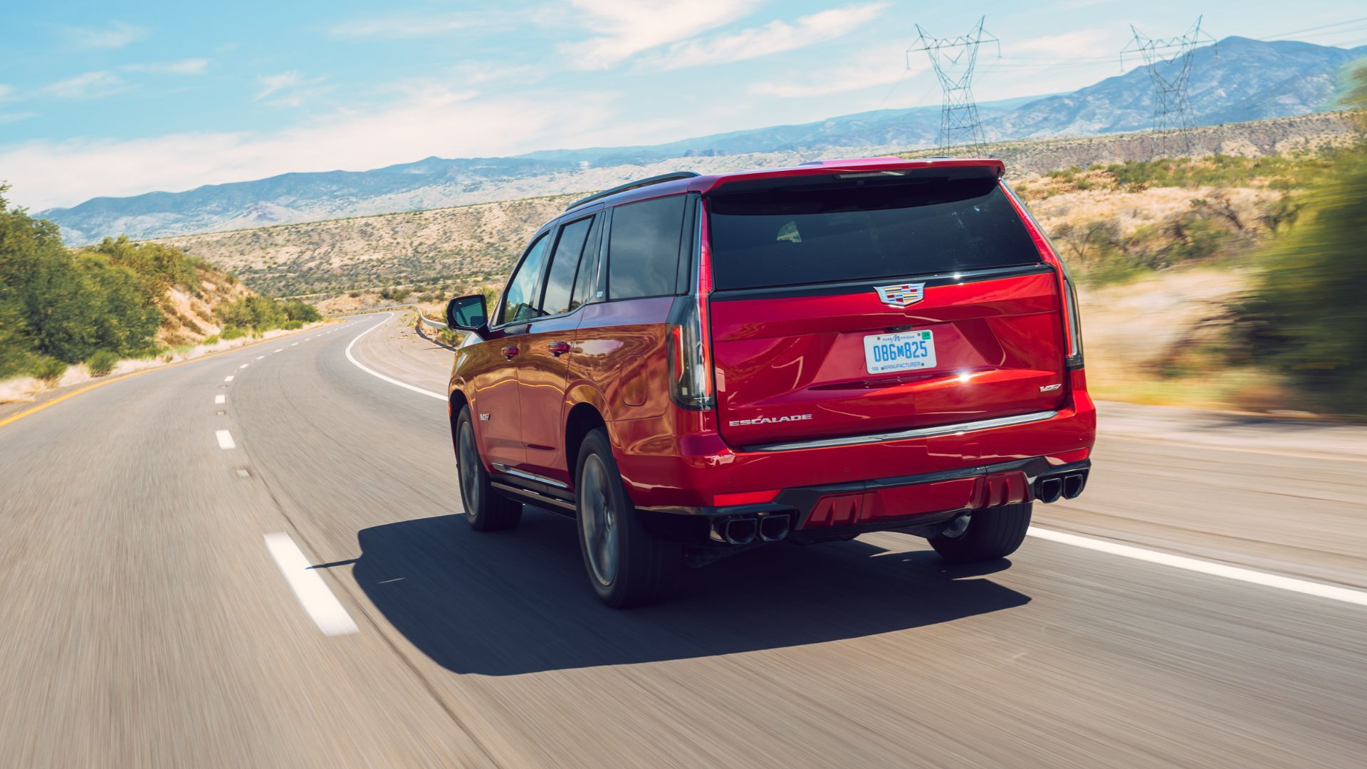 Dynamic rear 3/4 shot of a red 2023 Cadillac Escalade-V.