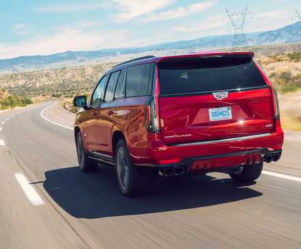 Dynamic rear 3/4 shot of a red 2023 Cadillac Escalade-V.