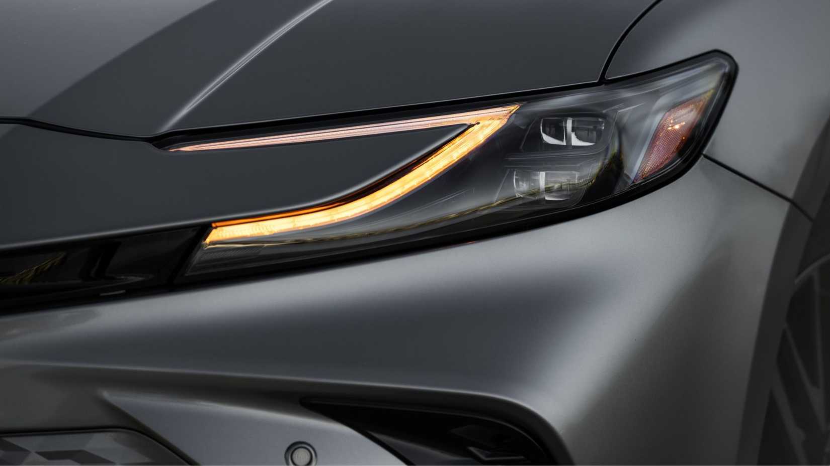 Close-up shot of the headlight on a gray 2026 Toyota Camry XSE AWD.