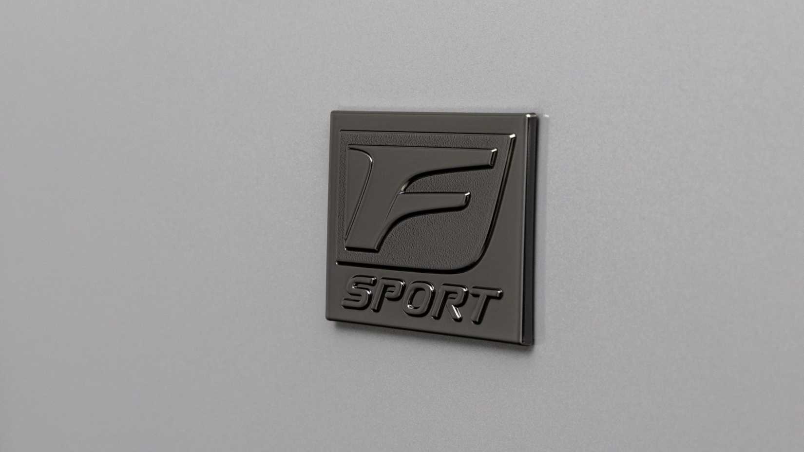 Close-up shot fo the 'F Sport' badging on a gray 2026 Lexus IS 350.