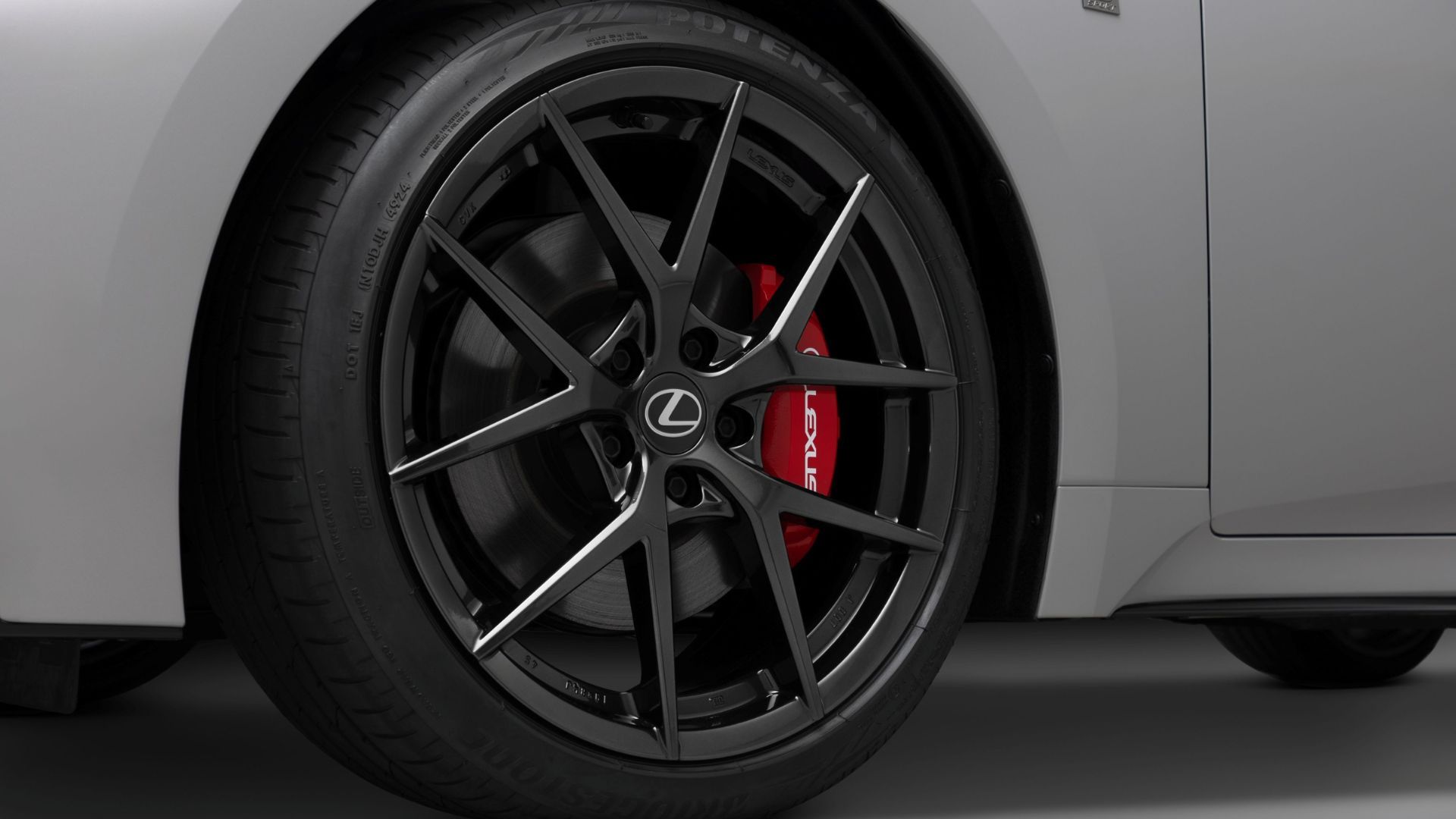 Close-up shot of the alloy wheel on a gray 2026 Lexus IS 350.