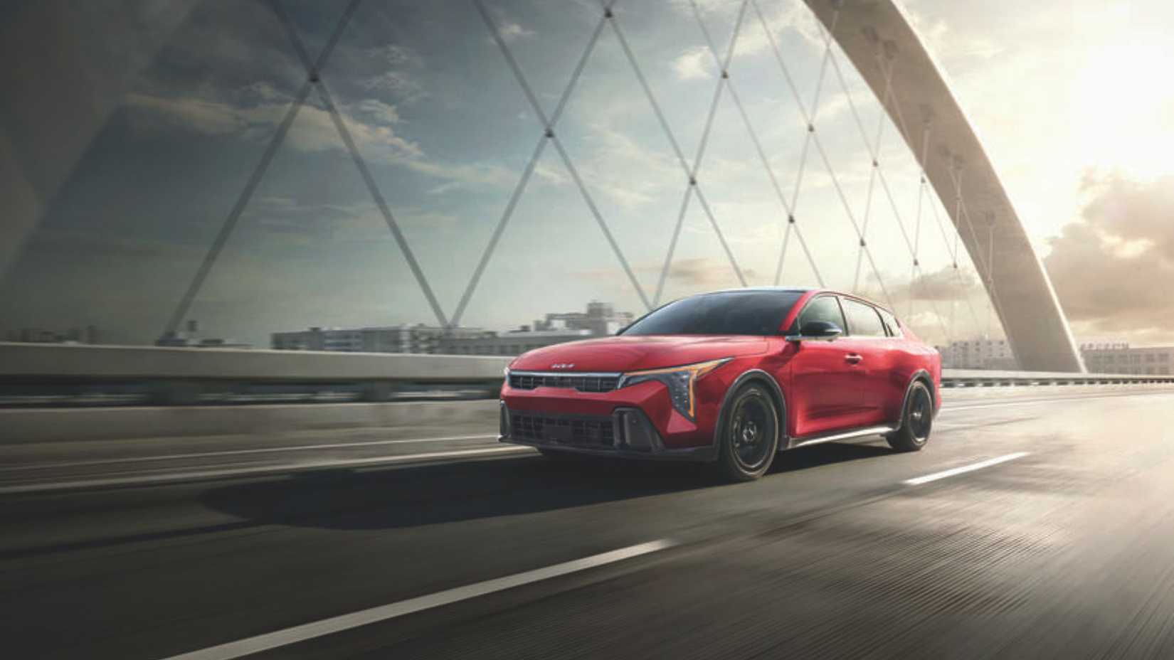 Dynamic front 3/4 shot of a red 2025 Kia K4.