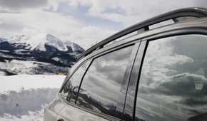 Close-up shot of the side of a 2026 Kia Sorento with a snow-capped mountain in the background.