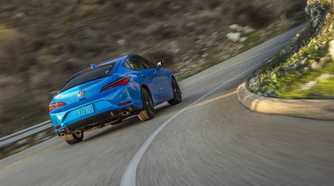 Rear 3/4 action shot of a 2026 Acura Integra