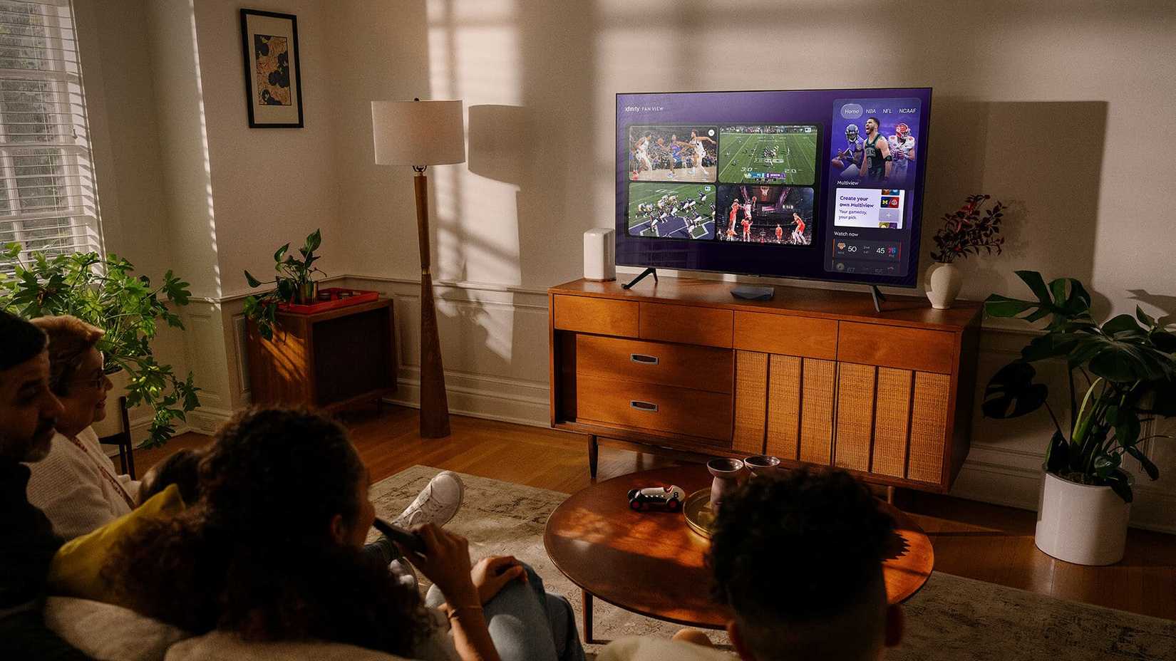 A family watching an XFinity TV in the living room.