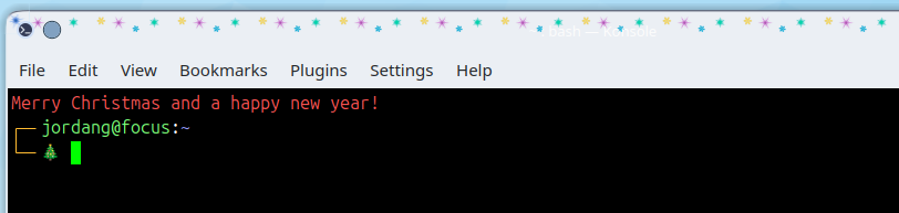 Uma saudação de feriado no topo de uma nova sessão do terminal Konsole com um emoji de árvore de Natal no prompt.