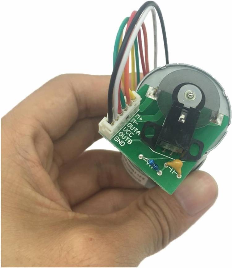 A Photoelectric Encoder JGB37-3530A DC Gear Motor 12V Optical Encoder 12-1600rpm being held in a hand