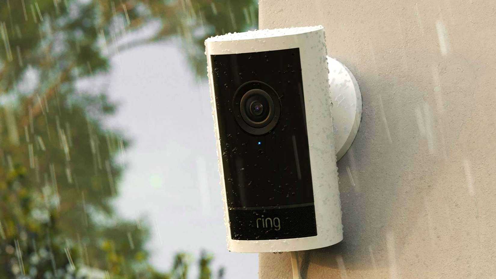 A Ring Pro camera in the rain on the side of a building.