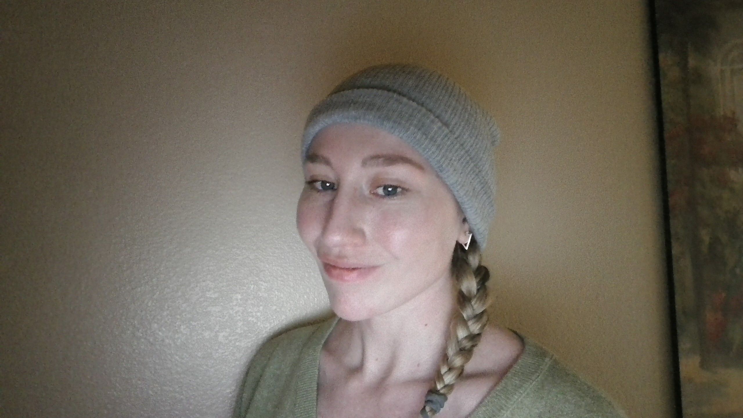 A woman using the Leggion 9i Gen 10's webcam in a dim environment.