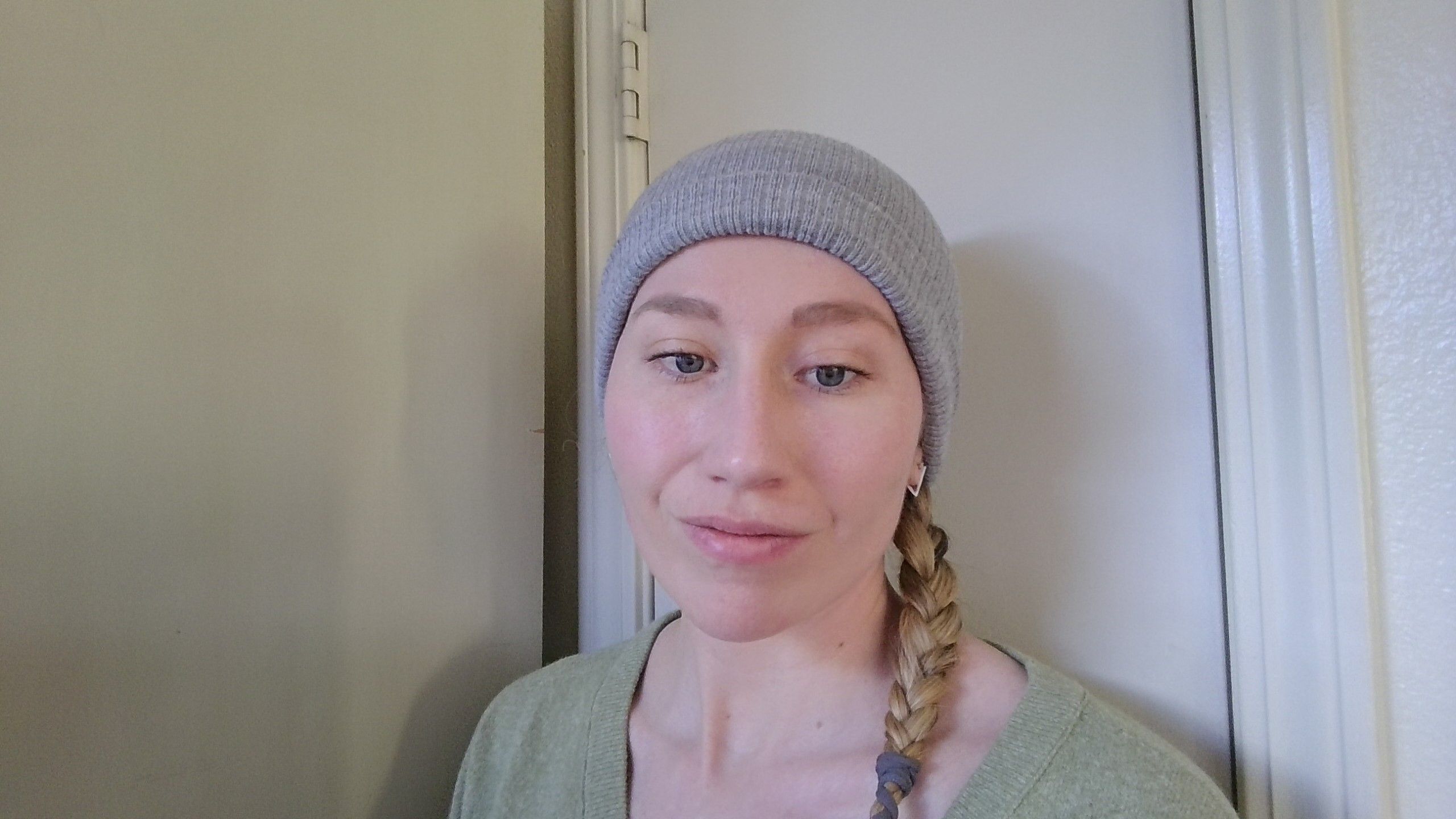 A woman using the Legion 9i Gen 10 laptop's webcam in a bright environment.