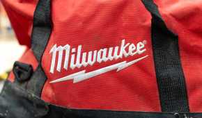 The Milwaukee logo embroidered in white on a red tool bag.