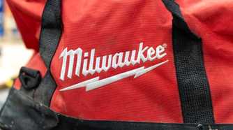 The Milwaukee logo embroidered in white on a red tool bag.
