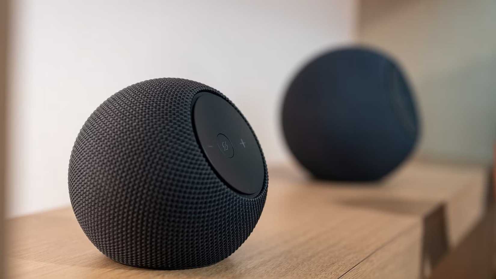 Amazon Echo Dot Max and Studio sitting on a shelf.