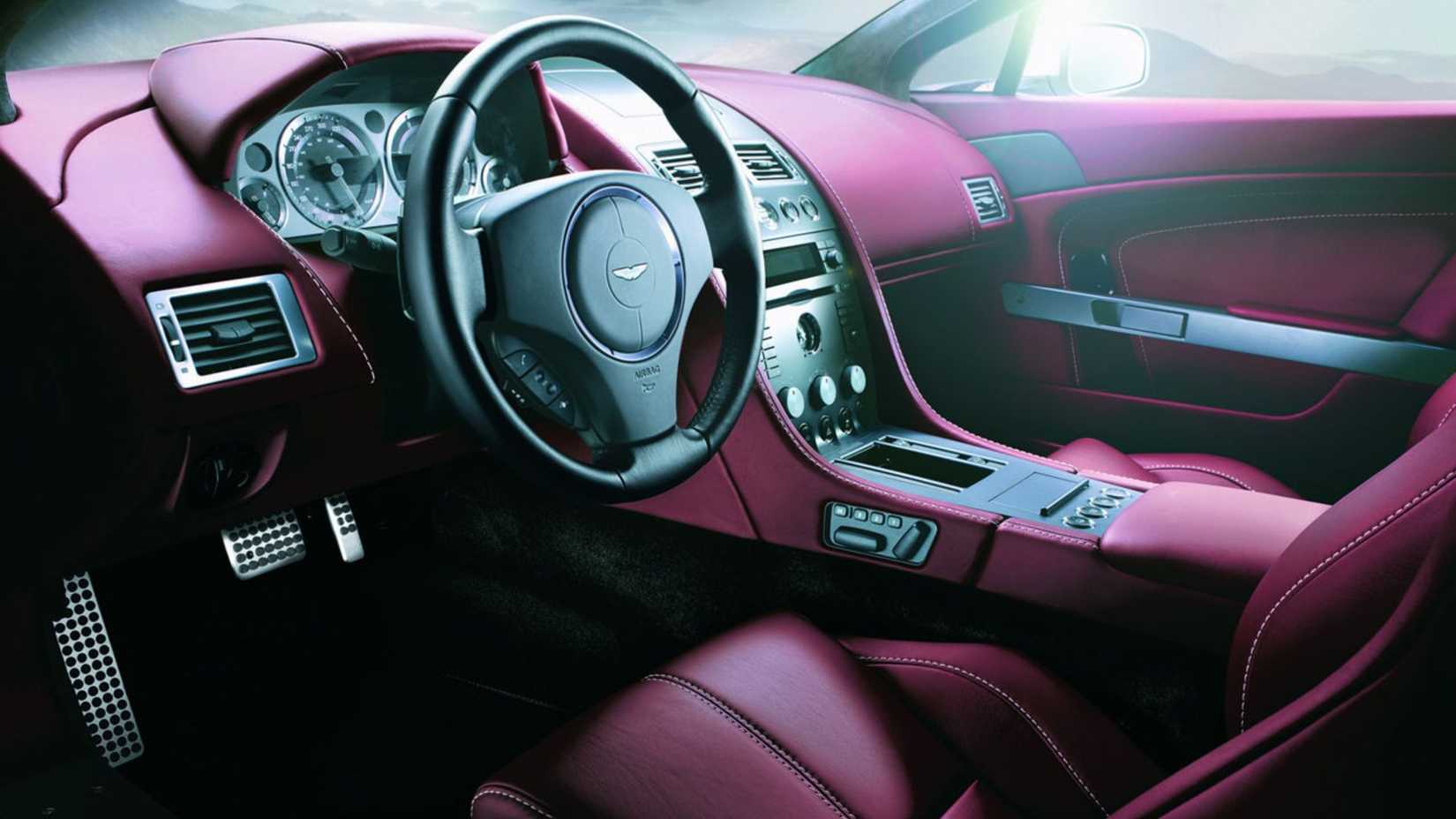 Close-up of the dashboard and red leather interior of a 2007 Aston Martin V8 Vantage Roadster.