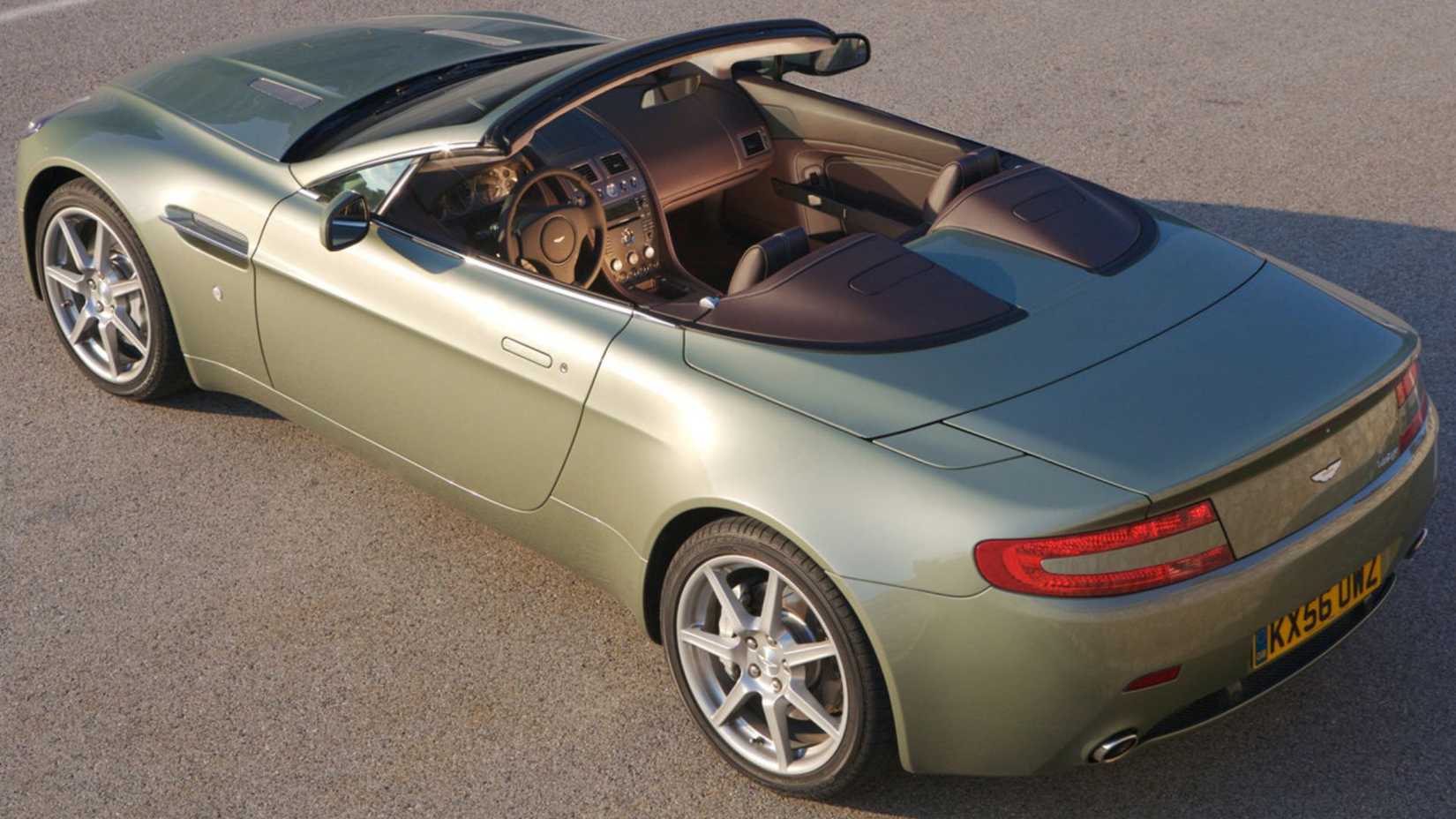 Static rear 3/4 overhead view of a green 2007 Aston Martin V8 Vantage Roadster.