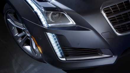 Close-up shot of the headlight on a gray 2014 Cadillac CTS.