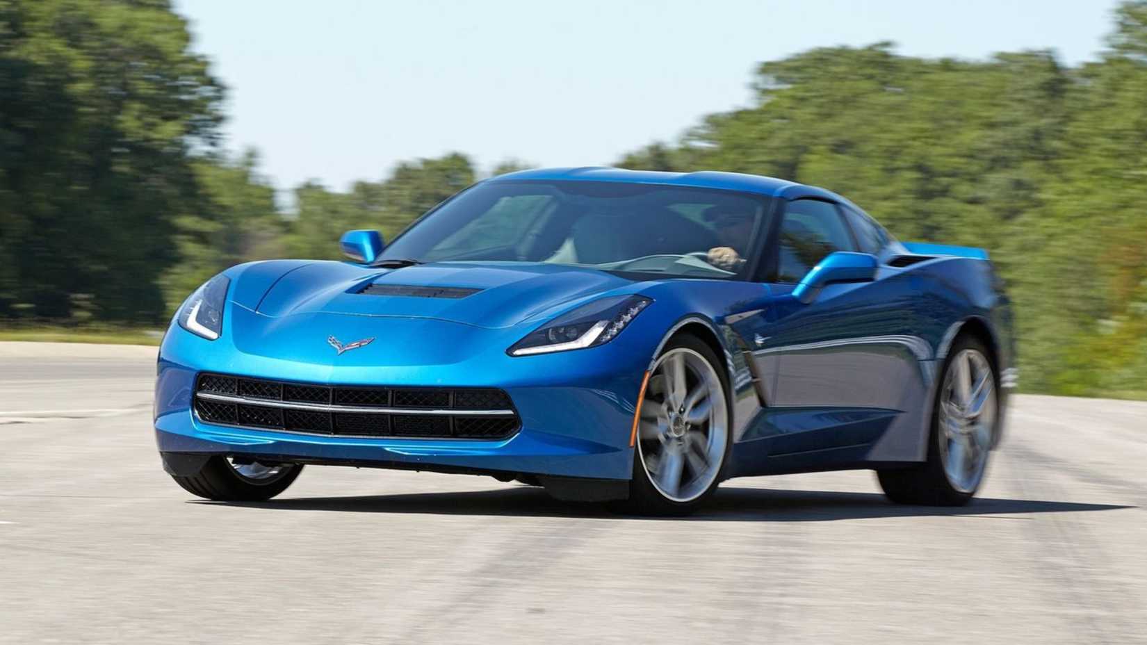 Dynamic front 3/4 shot of a blue 2014 Chevrolet Corvette C7 Stingray.